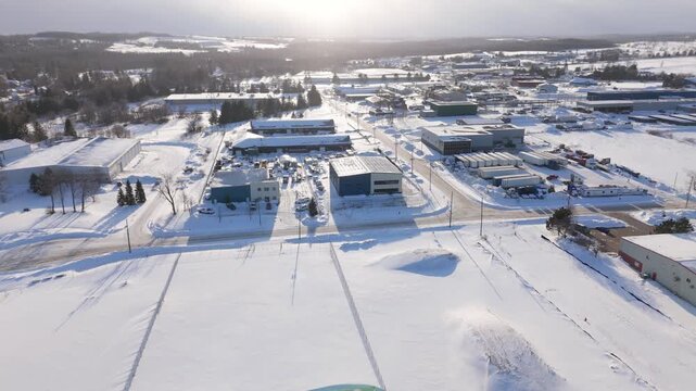 Snow Covered Factories In A Industrial Estate During Winter In Erin, Ontario, Canada. Aerial Flyover At Sunset.