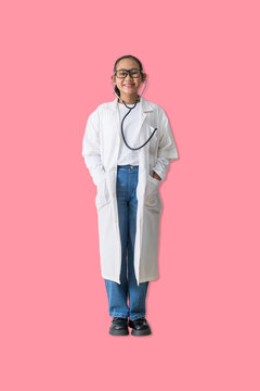 Smiling young woman dressed as a doctor stands calmly with hands in pockets, symbolizing approachability, trust, and a warm attitude toward healthcare