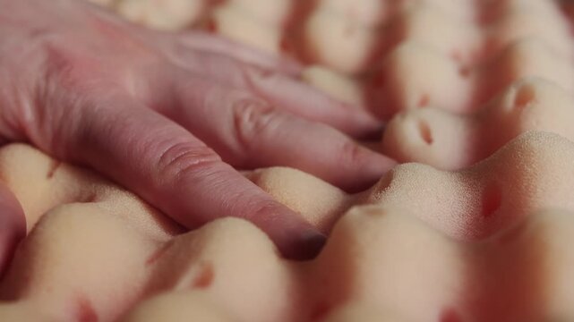 Hand pressing soft memory foam pillow, showing slow recovery and comfort ergonomic sleep concept. High quality 4k footage