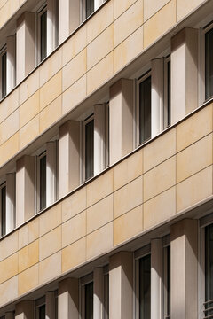 Minimal urban facade architecture in exterior view with modern windows showing geometric pattern and repetition for abstract building texture and clean rhythm