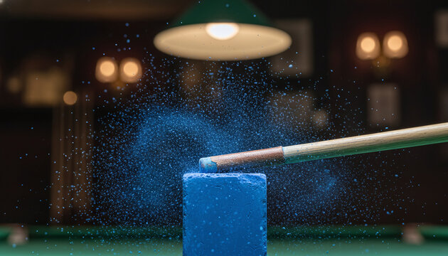 Chalking snooker cue leather tip with flying blue dust particles