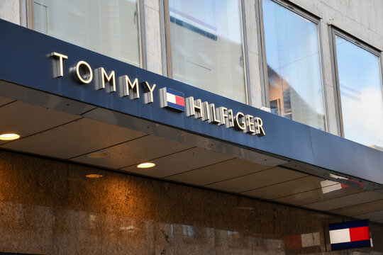 Tommy Hilfiger store exterior with illuminated brand logo and storefront signage in W&uuml;rzburg, Germany