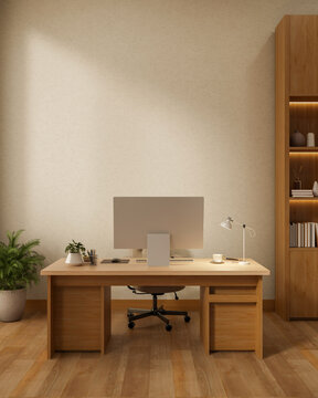 Computer on wooden table and chair aside bookshelf on parquet floor with white wall in office room.