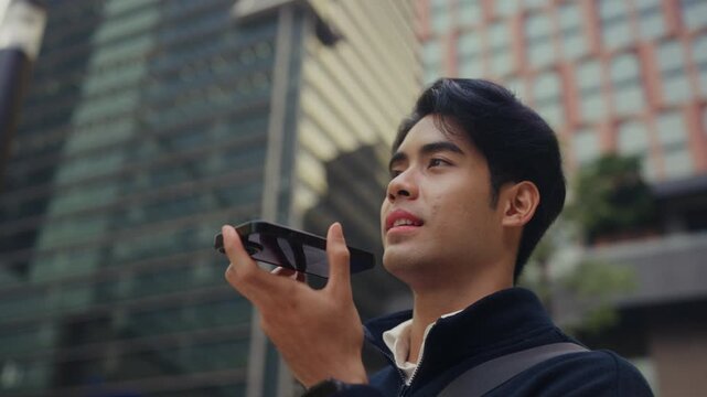 Young office worker steps out for a midday reset, talking on his smartphone during lunch, reflecting modern work life where flexible hours and soft hustle define the new concept of corporate life