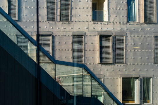 Modern urban facade with windows and diagonal stairs in blue steel pattern showing architecture design geometry for clean abstract city background