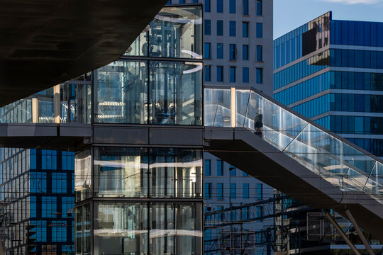 Modern urban bridge walkway of glass and steel linking building to city showing architecture connection and clean corporate passage in daylight