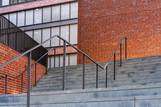 Modern urban stairs and steps on brick facade with railing showing geometry lines and contemporary architecture for clean minimal progress concept