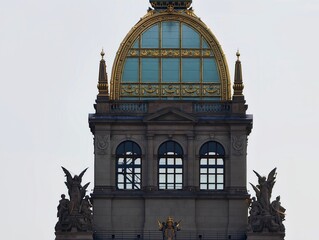 Elegant heritage building. Museum facade reflecting sunlight with ornate gilded dome and sculptures © Vladimir
