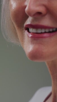 Elderly woman neck and good teeth smile. Old female tightens and stretches chin perfect skin. Care for senior persons medicine and treatment. Cosmetology or dermatology for wrinkles. Close up macro