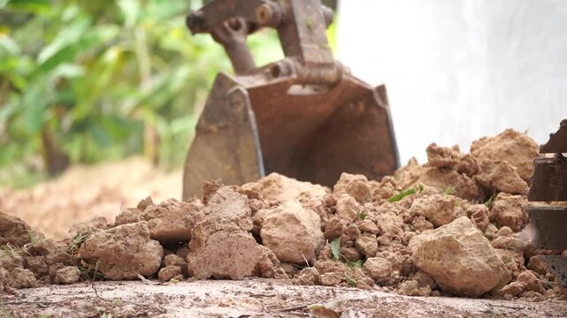 Excavation in Progress: A heavy-duty excavator diligently scoops up earth, revealing the raw power of machinery and the ongoing process of construction or groundwork.