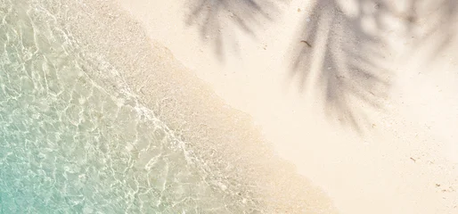 Fotobehang Tropisch Strand White sand beach and palm leaves shadows with tropical sea transparent water top view  © didecs