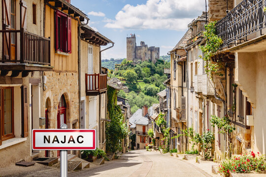 Main street in the village of Najac with added town sign illustration - France