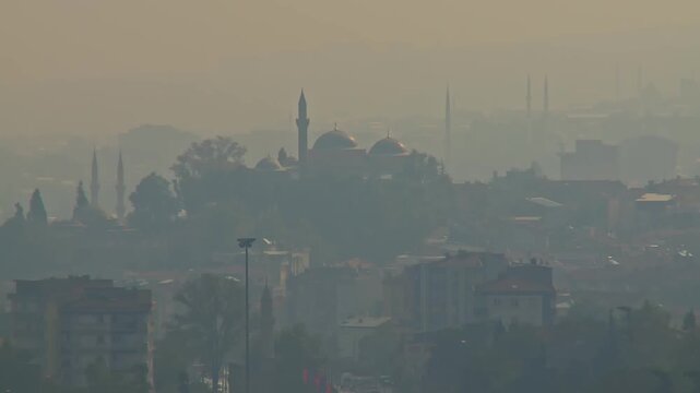 Majestic Panoramic View of Bursa Cityscape with Multiple Mosque Minarets in Thick Fog