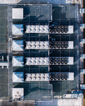 Aerial view of the data center rooftop with multiple industrial hvac cooling units managing thermal output for computing ai infrastructure, Warsaw, Masovian Voivodeship, Poland.