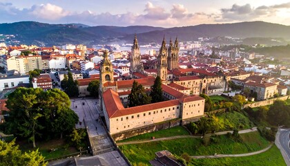 Fototapeta premium Aerial view showcases a historic city with towering spires and red roofs