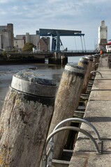 Fototapeta premium Husum is a picturesque town located in Schleswig-Holstein, Germany, known for its maritime heritage, charming architecture, and scenic surroundings. Harbor at low tide.