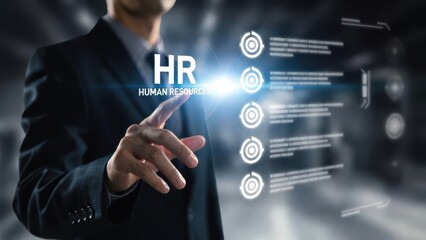 Fototapeta premium A business professional interacting with a digital interface featuring HR-related icons such as gears, targets, and charts. The image symbolizes the integration of technology in human resources manage