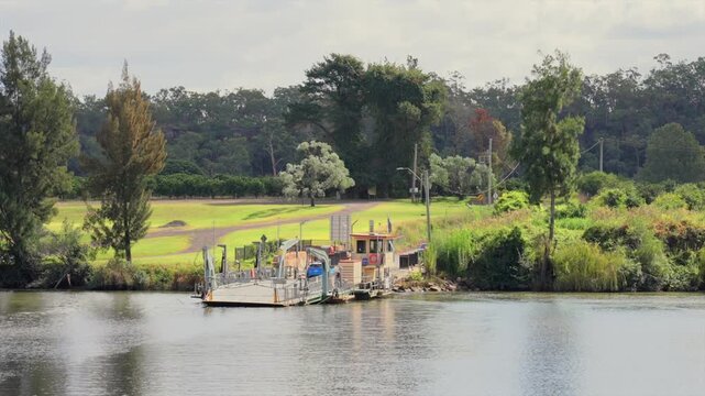 Cars driving onto the Sackville ferry to cross the Hawkesbury river, Australia