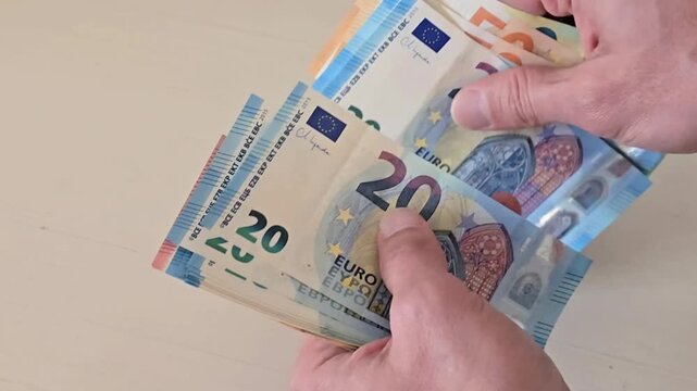 hands counting euro banknotes on table, financial concept of income savings payment and business cash flow with european currency