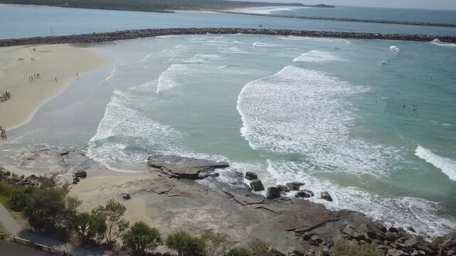 Turners Beach sits on the Eastern Australian coastline near the town of Yamba and houses many surfers as they get a salty taste of the South Pacific Ocean. The Yamba Breakwater divides the sea water.