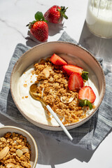 Balanced breakfast with yogurt, granola and strawberry on marble background. Top view © Kufotos