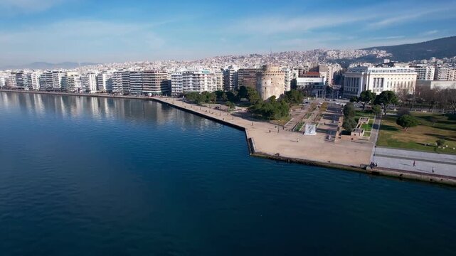 Aerial footage moving away from the white tower landmark revealing the thessaloniki waterfront in greece