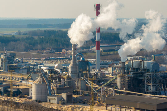 Aerial view of large industrial wood processing plant consuming raw materials and emitting smoke from chimneys, Grajewo, Podlaskie Voivodeship, Poland.