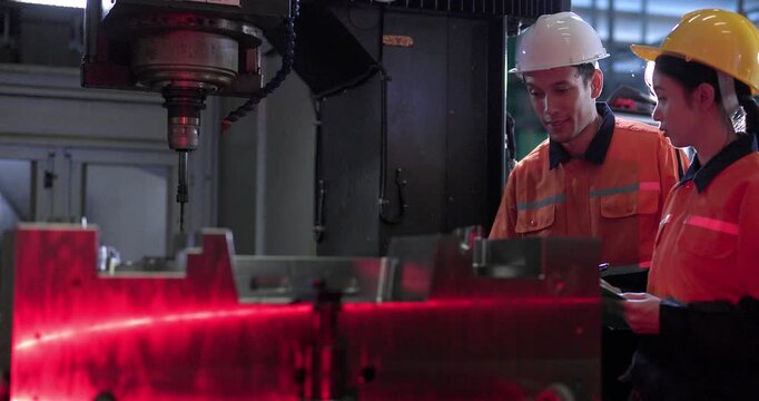 Technicians monitor a CNC machining process inside the machine enclosure during production setup, highlighting inspection, workflow control, and precision manufacturing.
