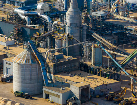 Aerial view of industrial facility with silos, conveyors, and machinery processing wood byproducts. Recycling materials, Grajewo, Podlaskie Voivodeship, Poland.