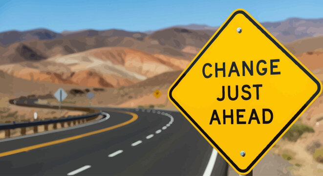 A curved road stretches ahead with a change sign in a desert landscape.