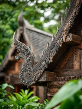 Hand Carved Wooden Roof Detail of a Majestic Traditional Thai Temple Nestled in Lush Greenery