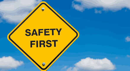 A yellow diamond-shaped sign reading SAFETY FIRST hangs under a blue sky with white clouds.