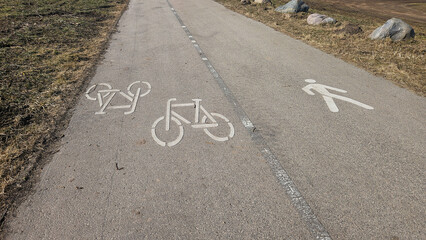 Pedestrian and bicycle lane markings on shared asphalt path in Riga Latvia © Svetlana