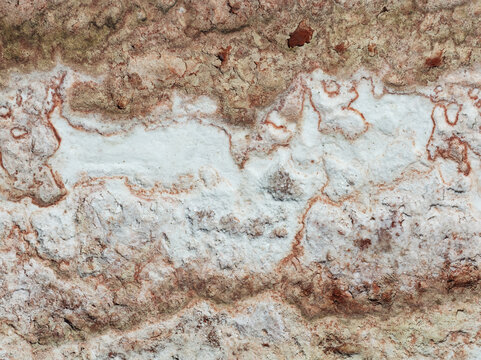 Aerial view of the stark, textured earth reveals layers of white and salt deposits, resembling abstract art, Walvis Bay, Erongo Region, Namibia.