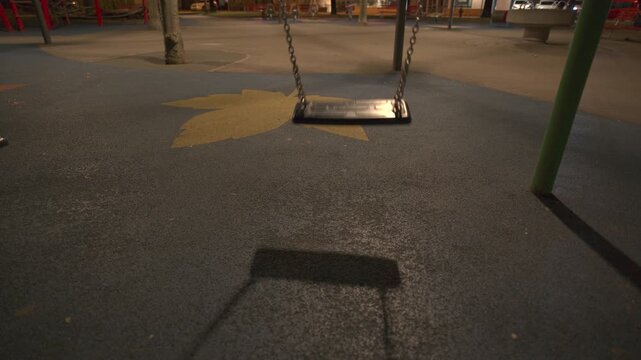 A children's swing swings empty