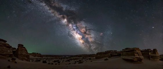 Astrophotography of the Milky Way Arch over Desert Landscape © Khatthaphone