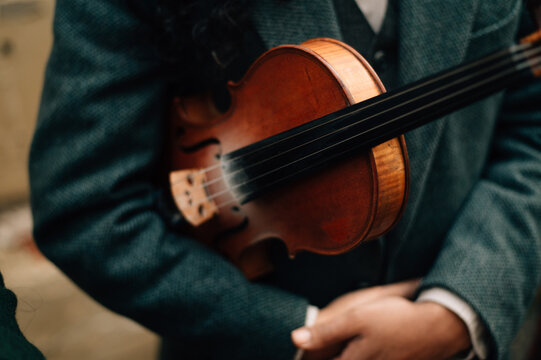 A violin in the hands of a musician