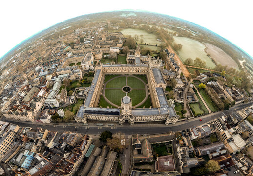 Aerial view of a historic quadrangle framed by golden-stone buildings and manicured lawns, a tapestry of academia unfolds under a vast sky, Oxford, England, United Kingdom.