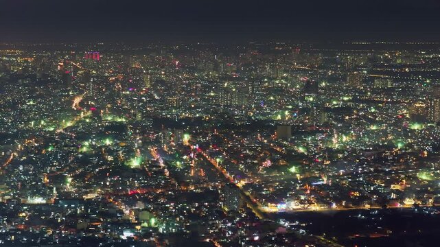 Aerial view of Saigon cityscape at Lunar New Year's Eve 2026, colorful fire works lighting the night skies with vivid multi colors in Southern Vietnam. Night celebration