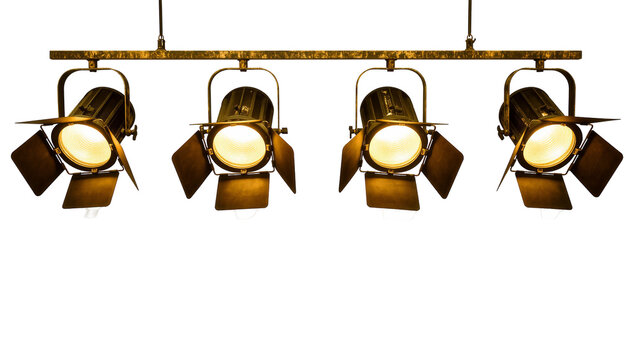 Isolated vintage film set spotlights with warm glowing lamps on a distressed metal bar