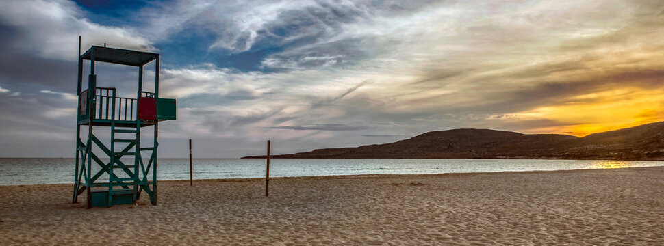 lifeguard high chair on the beach Simos on the island of Elafonisos with sunset in peloponnese , Greece