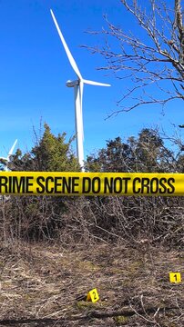 Crime scene investigation near a rural wind turbine farm