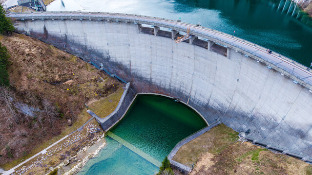 Aerial view of the imposing Klaus Dam with its concrete facade reflecting the diffused light, contrasting with the dark waters below, Klaus an der Pyhrnbahn, Oberosterreich, Austria.