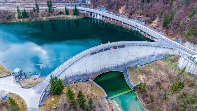 Aerial view of the imposing Staudamm Klaus dam holding back a dark lake against a backdrop of trees, Klaus an der Pyhrnbahn, Oberosterreich, Austria.