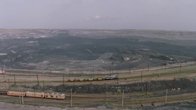 Industrial trains moving through a large open cast coal mining quarry in Kazakhstan