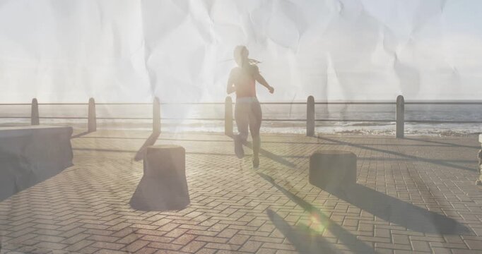 Female runner starting mid-stride, running to railing past bollards, exercising under sun backlight