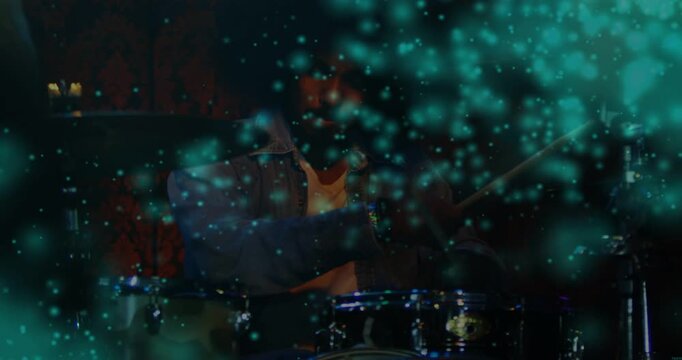 Male drummer raising arm striking snare and playing music while teal overlay clearing face emerging