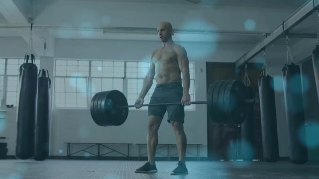 Man starting hip hinge deadlifting training strength gym blue bokeh overlay drifting across frame