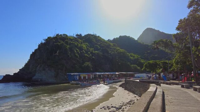 A panoramic view of a sunny day on the boardwalk and pier in the beach town of Choroni, Aragua, Venezuela