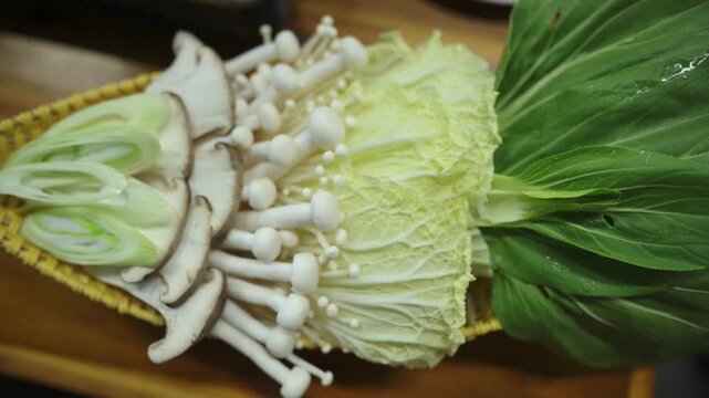 Fresh Hotpot Ingredients Napa Cabbage Enoki Arranged On Bamboo Basket In Restaurant Kitchen, Chef Prepping Garnish, Crisp Leafy Greens And Sliced Shiitake, Closeup Texture And Moisture, Raw Produce